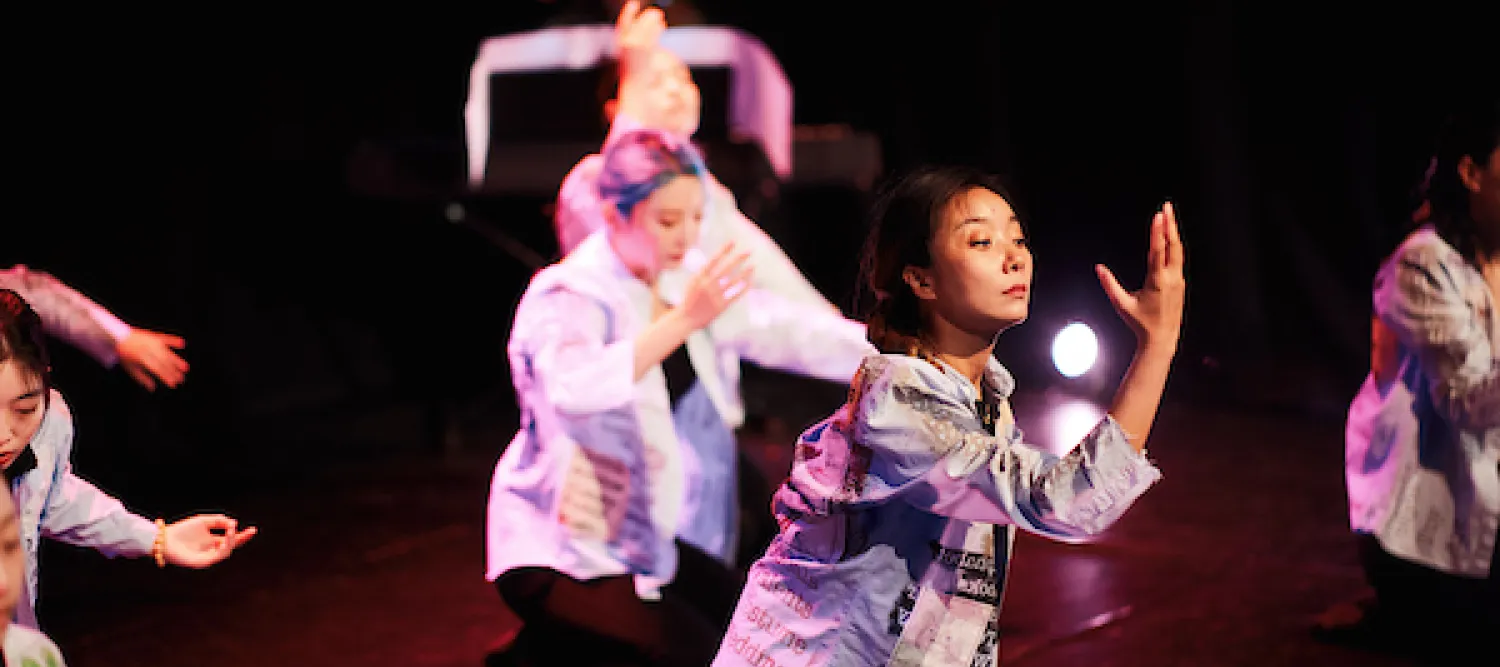A photo of people dancing on stage
