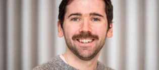 A photo of Dr Dom Cairns-Gibson