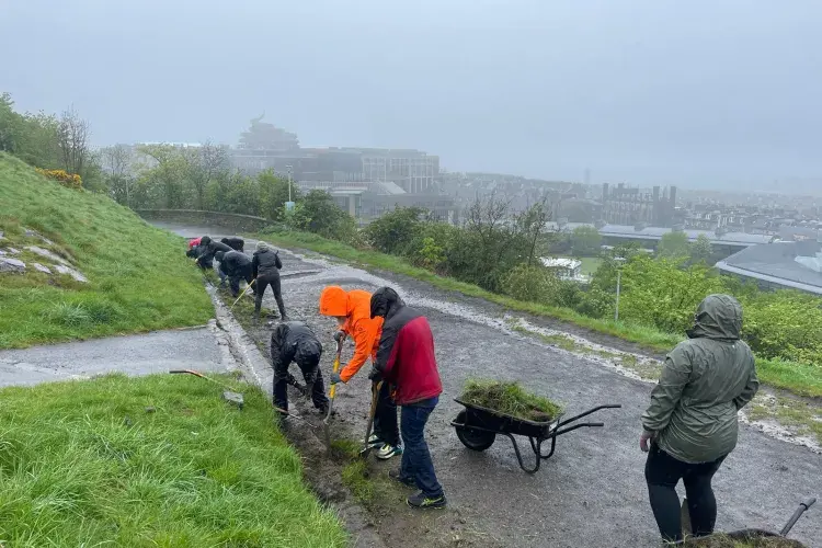 Clearing rain guttering for the Edinburgh & Lothians Greenspace Trust at Calton Hill staff volunteering