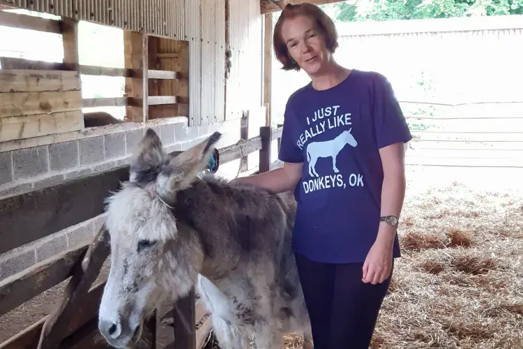 Karen Scott with Dylan, one of the resident donkeys at the Scottish Borders Donkey Sanctuary. Staff volunteering.