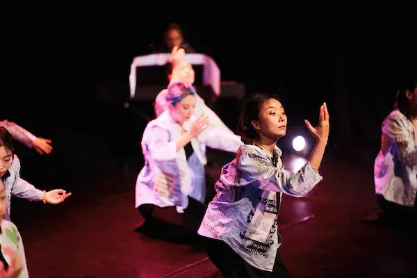 A photo of people dancing on stage