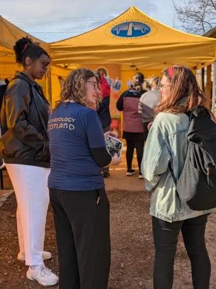 Three women talking at an Archaeology Scotland community dig in 2024.