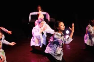 A photo of people dancing on stage
