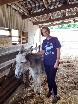 Karen Scott with Dylan, one of the resident donkeys at the Scottish Borders Donkey Sanctuary. Staff volunteering.