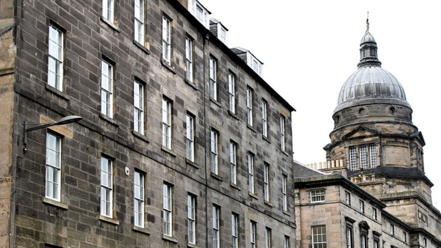 Photograph of front of grey 4-storey building