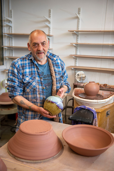 Artist showcasing hand made pottery at studio The Potter of Leith