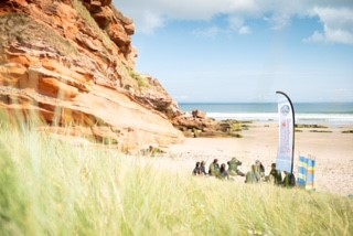 Surfers on a beach - community project grant