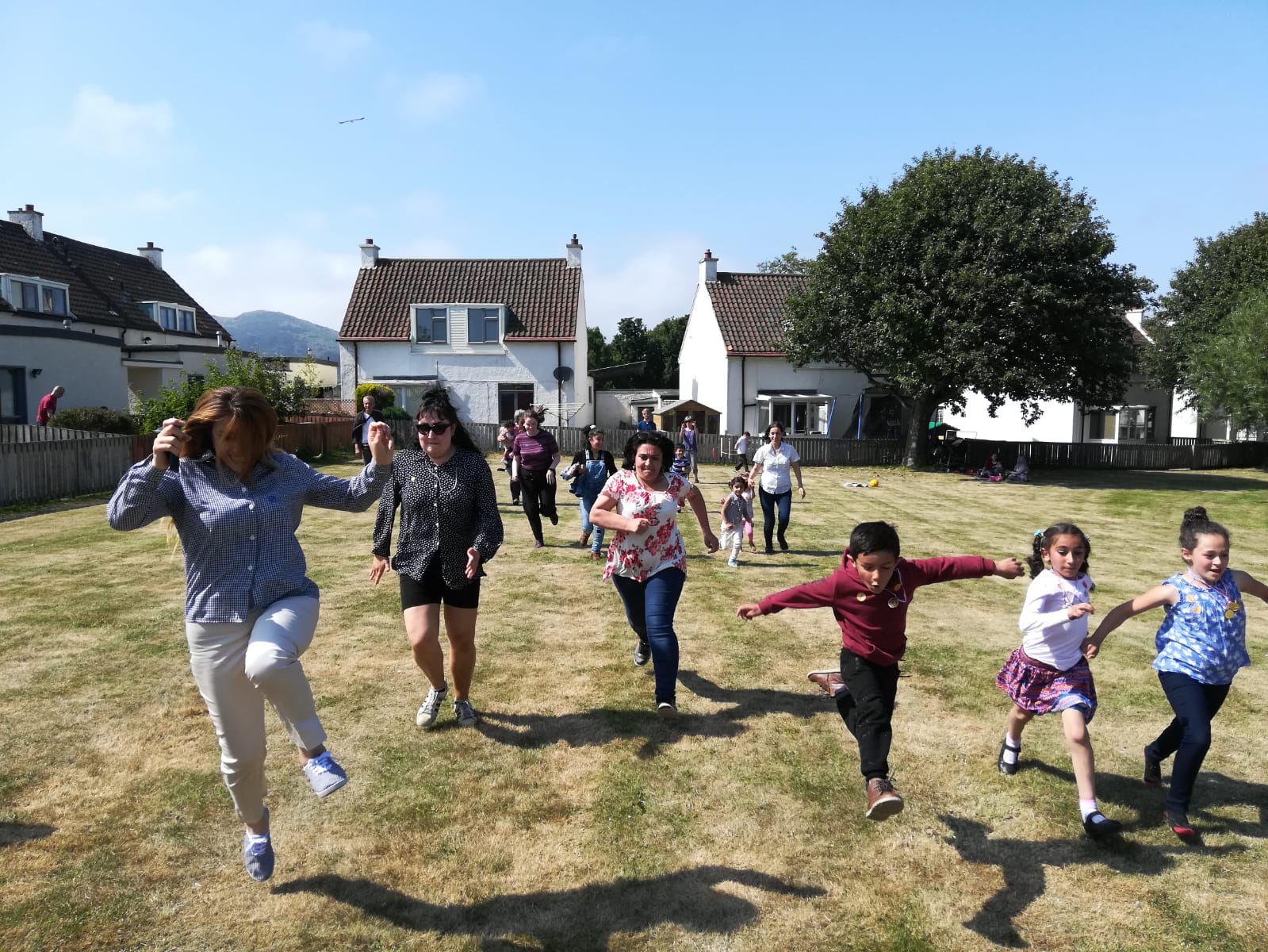 Photo shows children playing outside and running towards the camera